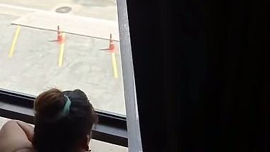 Lady fucks in front of a transparent glass in Indian porn